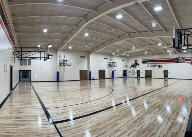 Electrical and lighting fixtures in a school gym.
