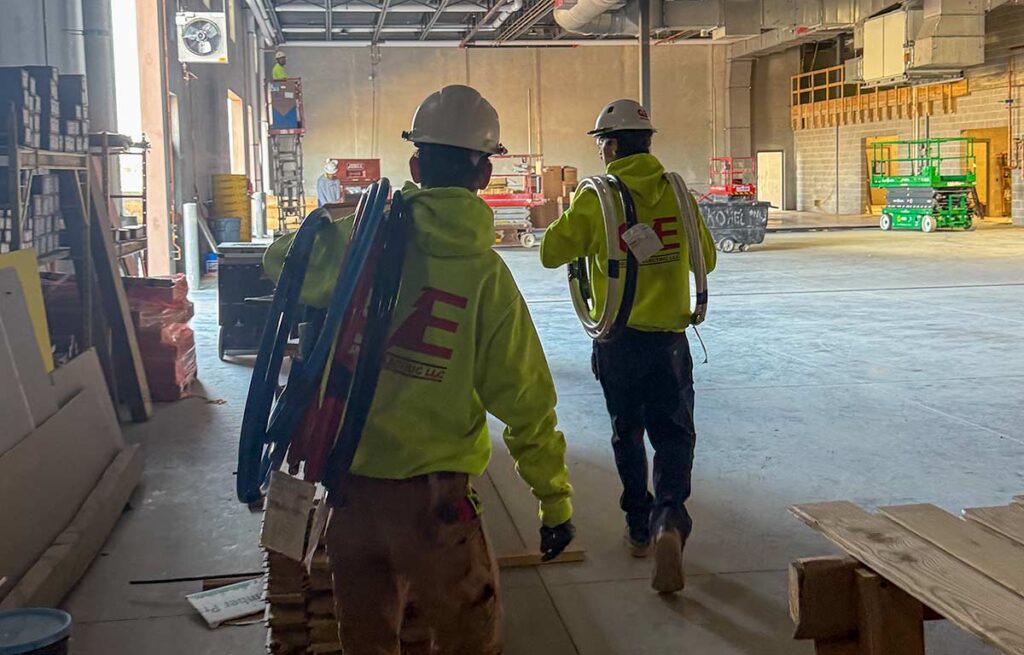 Two electricians working in a commercial location.